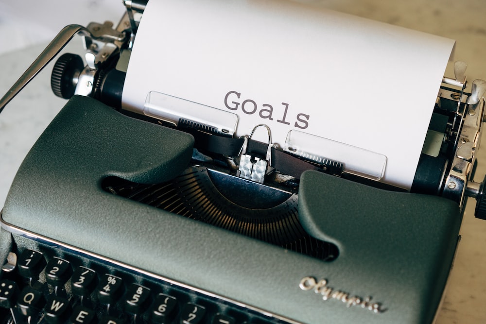 black and white typewriter on green textile